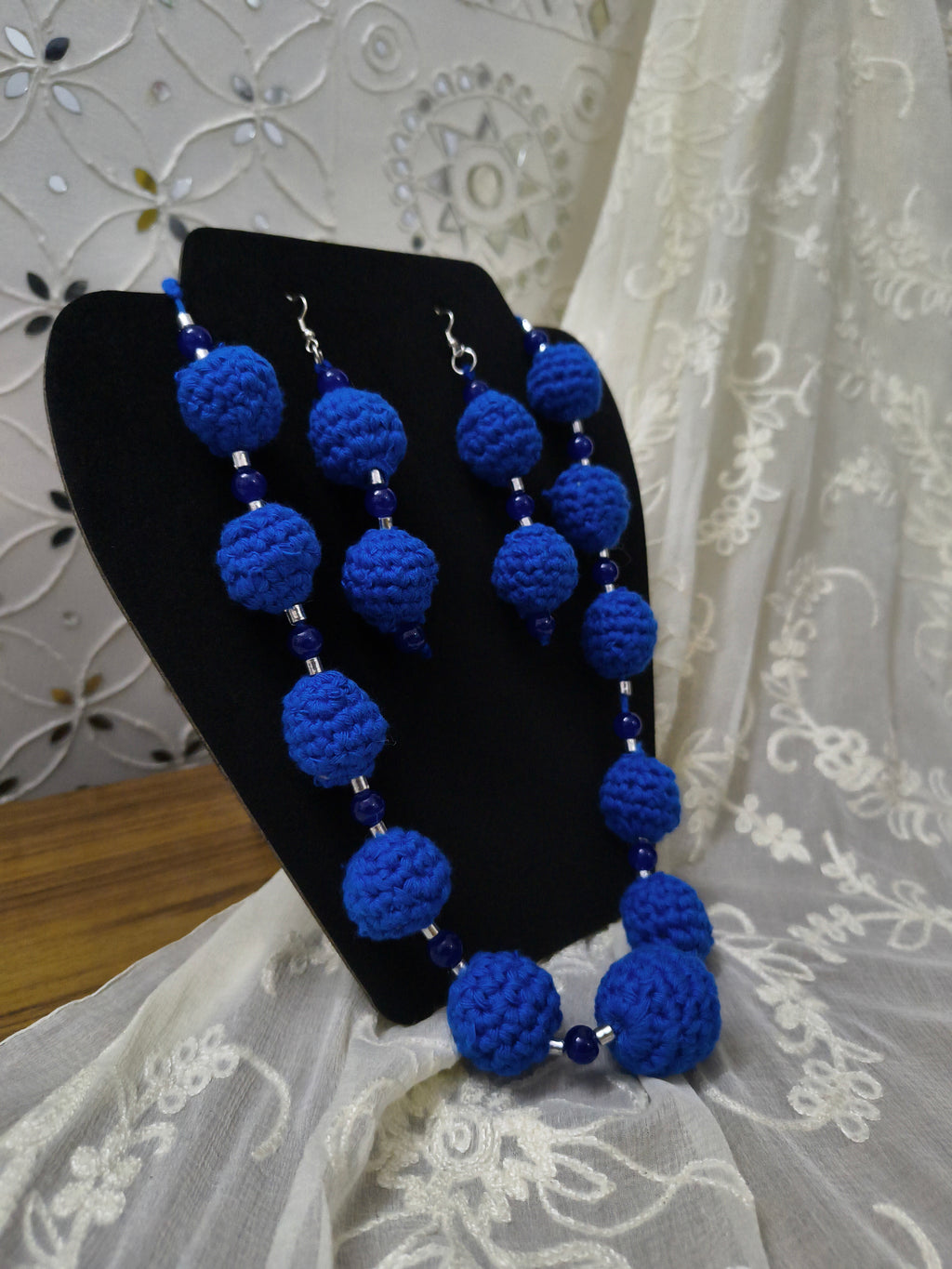 Blue crochet necklace and earrings set for festive and everyday styling