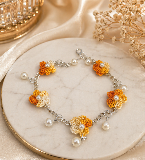 marigold crochet floral charm bracelet with pearl drops and chain detail