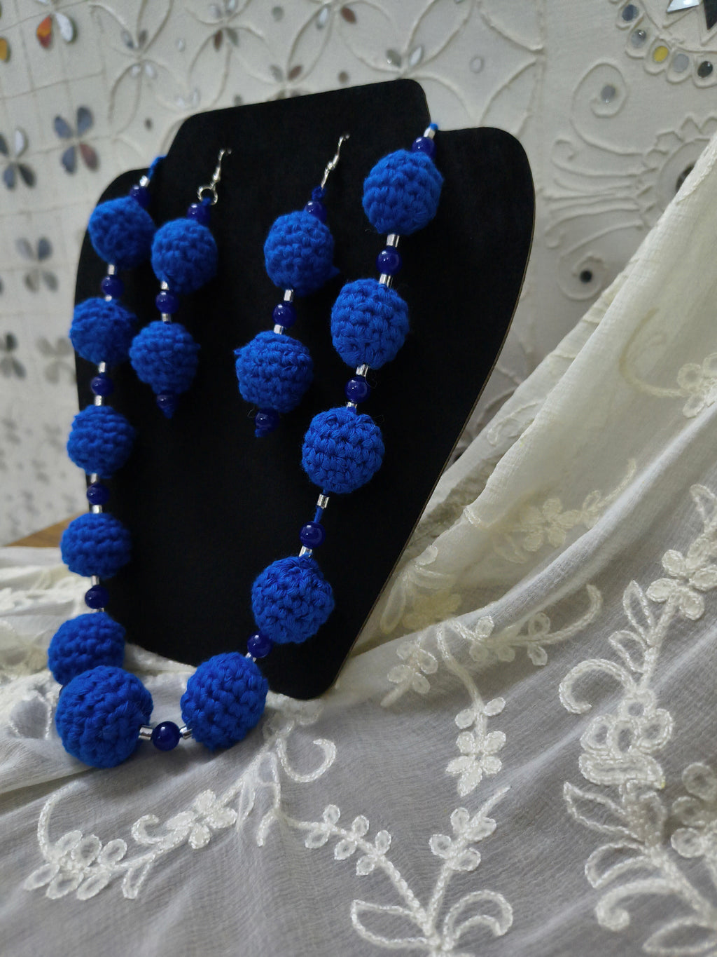 Close up of blue crochet beaded necklace showing handmade texture