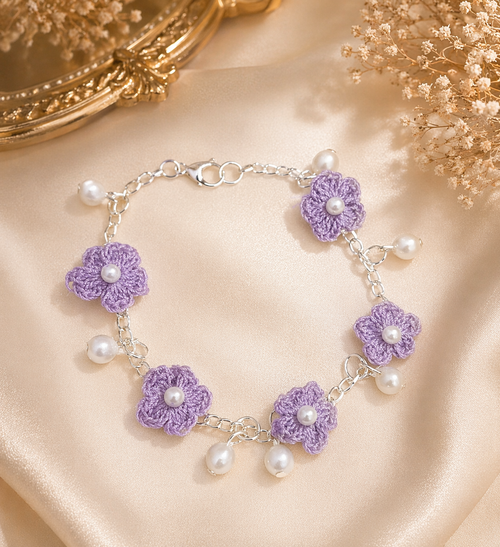 Close up of lavender crochet floral charm bracelet with pearl drops